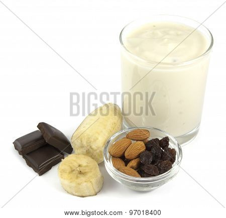 Yogurt desert with banana, chocolate, almond and raisins isolated on white background