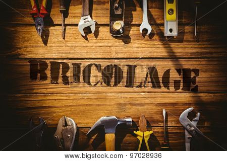 The word bricolage against desk with tools
