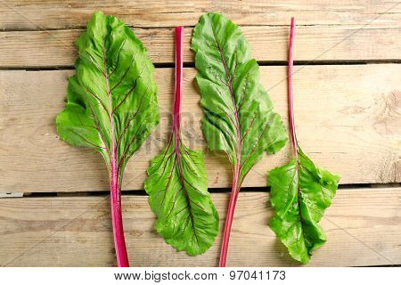 Fresh swiss chard on wooden table, close up