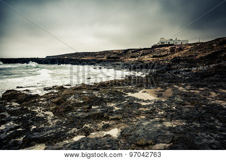 seawaves on a rocky shore at magnificent dusk