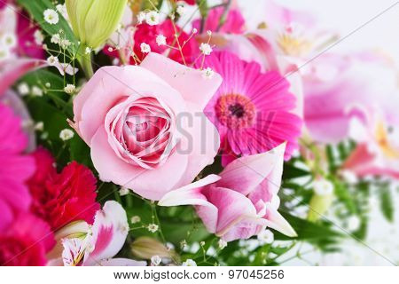 Pinkish tone flower bouquet, with focus on light pink rose. shallow depth of field. high key.