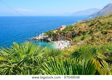 Paradise landscape with beach, sea, mountain, and tropical trees, Italy, Sicily, San Vito Lo Capo. Nature reserve Zingaro.
