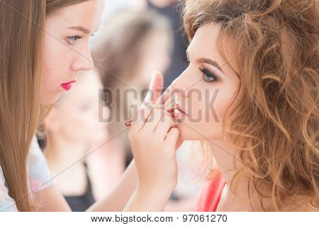 Professional Make-up artist doing glamour model makeup at work