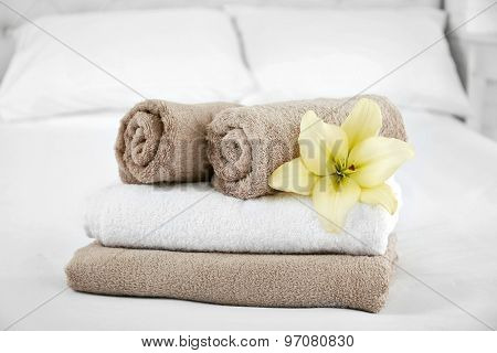 Freshly laundered fluffy towels in bedroom interior
