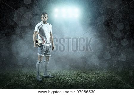 Soccer player with ball in action outdoors
