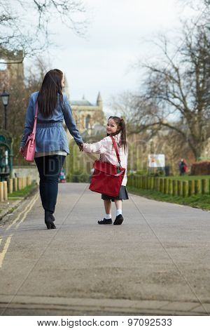 Mother Walking Daughter To School Along Path