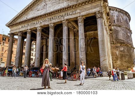 ROME, ITALY - MAY 9, 2014: Tourists visit the Pantheon at the Piazza della Rotonda. Pantheon is a famous monument of ancient Roman culture the temple of all the gods built in the 2nd century.