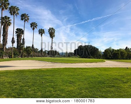 green golf field and blue cloudy sky. american landscape.