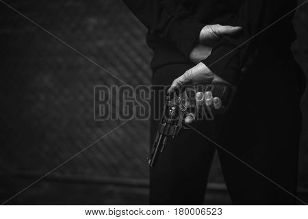 Patient and dangerous. Senseless felonious mad man standing on a dark street holding a gun and hiding it behind his back