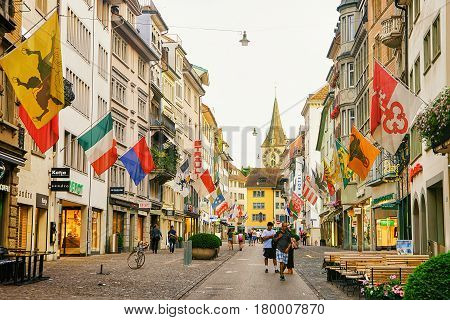 People At Rennweg Pedestrian Street With Flags In Zurich