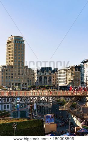 Lausanne Switzerland - August 26 2016: Le Flon district with Grand pont bridge and Bel Air Tower in Lausanne in Switzerland. People on the background