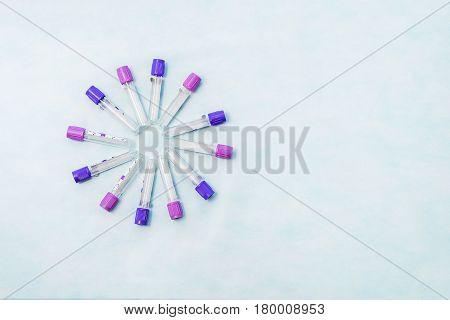 Test tubes for laboratory diagnosis blood tests on a blue background.