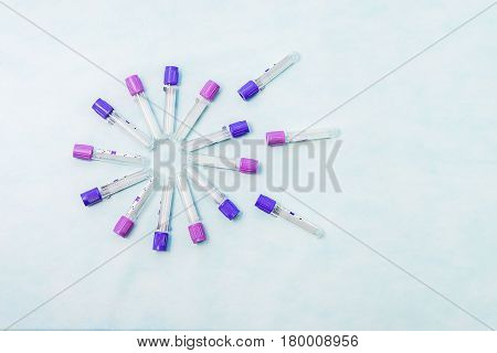 Test tubes for laboratory diagnosis blood tests on a blue background.