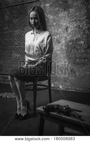 Where am I. Restless anxious scared woman looking all around her and spotting a gun while being kept hostage in some dark place
