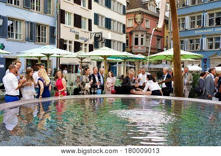 People And Fountain On Square Munsterhof Of Zurich
