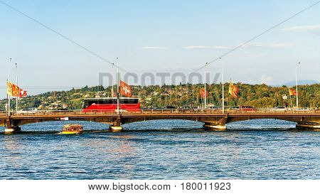 Bus on Bergues Bridge over Geneva Lake in summer Geneva Switzerland.