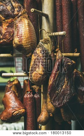 Variety of traditional Hungarian smoked meat and sausages hanging on Sunday farmers' market at Szimpla Kert ruin pub in Jewish quarter of Budapest
