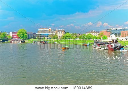 Krakow Poland - May 1 2014: Excursion Ferry at the embankment of Visla River in Krakow Poland. People on the background