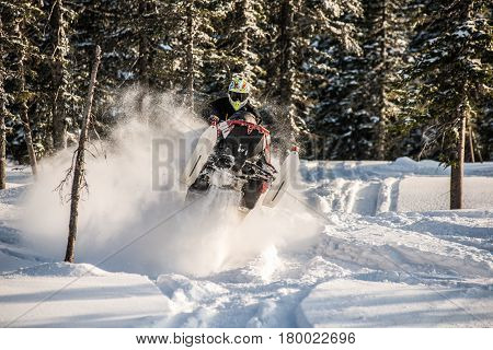 Rider on the snowmobile in the mountains ski resort in Amut Russia.