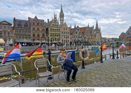 Girl On Embankment On Korenlei And Graslei Canal In Gent