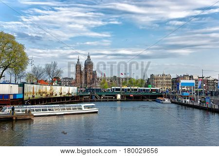 Canal Boats And St Nicholas Church At Open Havenfront Amsterdam