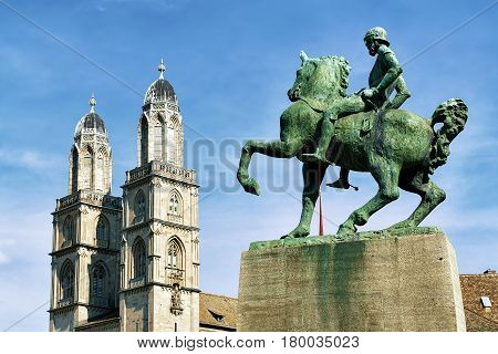 Zurich Switzerland - September 2 2016: Hans Waldmann monument and Twin towers of Grossmunster Church in Zurich Switzerland