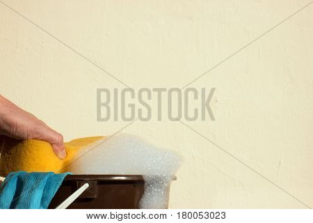 Hand grips sponge which is a foam. Bucket with soap and rags for washing.