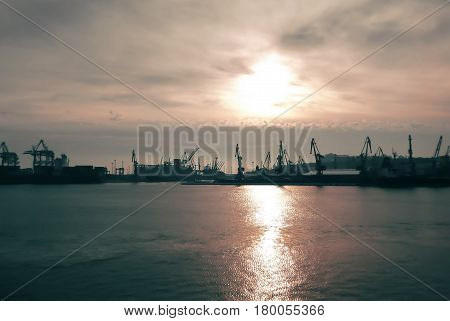 Logistics and transportation of Container Cargo ship with working crane bridge in seaport.the ocean