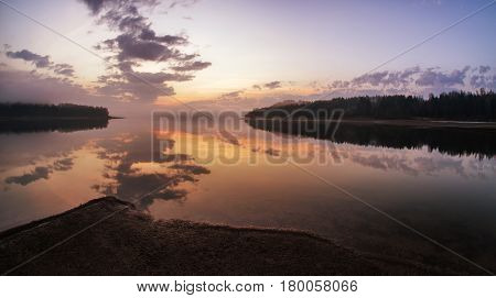 Sunrise on lake Liptovska Mara Slovakia. Mirror reflection on water