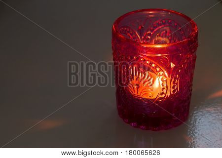 pink candle and light bule candle on a table .