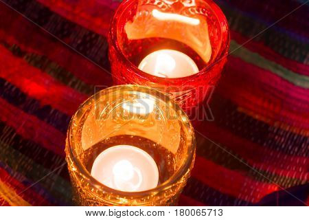 pink candle and light blue candle on a table .