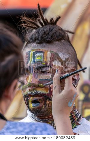 TIMISOARA ROMANIA - MARCH 31 2017: Face and body painting of a man. 3D art symbolizing on live at the street inside the CheckART Carnival organized by the City Hall Timisoara. Liberty Square.