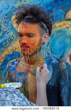 TIMISOARA ROMANIA - MARCH 31 2017: Face and body painting of a man. 3D art symbolizing on live at the street inside the CheckART Carnival organized by the City Hall Timisoara. Liberty Square.