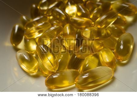 Evening primrose oil supplement capsules on the plate