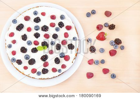 Biscuit cake with cream and berries. Yogurt pound cake for breakfast with whipped cream and fresh berries. Biscuit with berries and delicious cream. Summer berry cake.