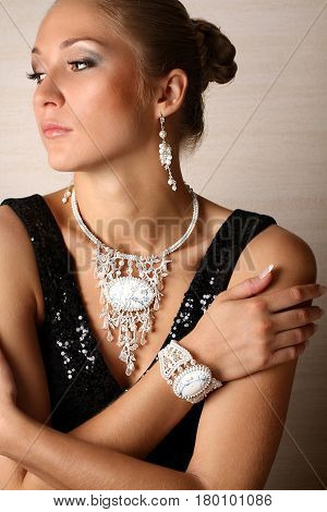 young woman portrait with beautiful jewelry looking to the left