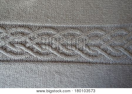 Grey handmade knit fabric with plait pattern