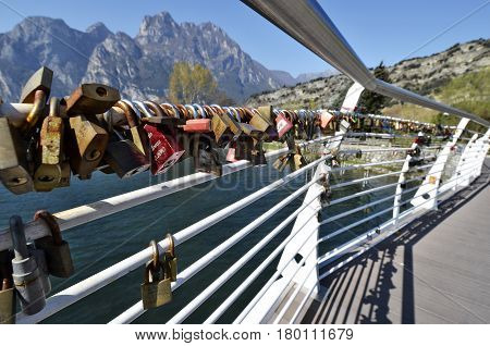 Torbole Italy - March 28 2017: Love padlocks on the bridge of the river Sarca at Torbole