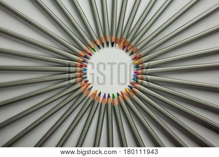 Set of colored pencils isolated against the white background. Rays of pencils.