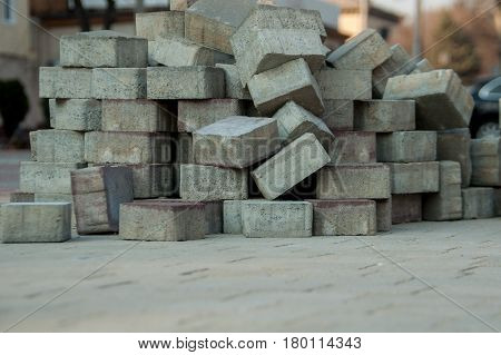 Laying colored paving tiles outside in the park