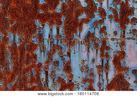 rusty metal plate with flaking blue paint abstract background texture
