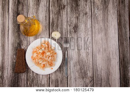 Sour Cabbage On A Plate, Vegetable Oil And Black Bread On A Wooden Background