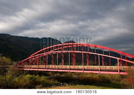 Red bridge in Okuhida onsen autumn season Kyoto Japan.