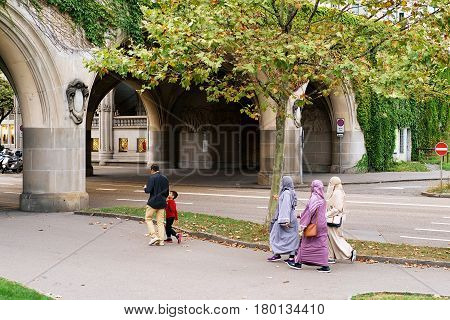 Zurich Switzerland - September 2 2016: Traditional muslim family with husband and a child and three women in hijabs in the streets of Zurich Switzerland