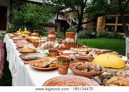 table with homemade moldavian food in clay dishes
