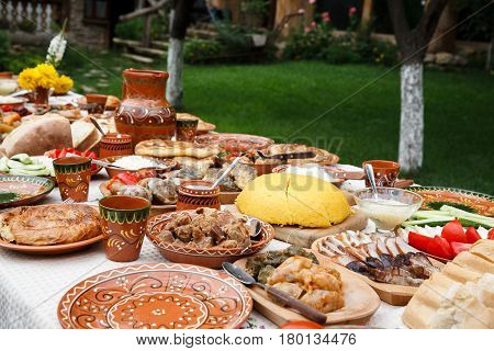 table with homemade moldavian food in clay dishes