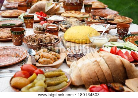 table with homemade moldavian food in clay dishes