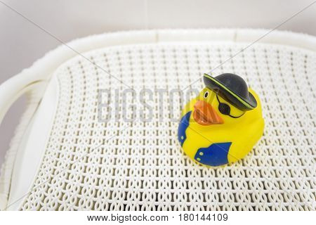 Close up of small yellow rubber pirate duck on white background in bathroom