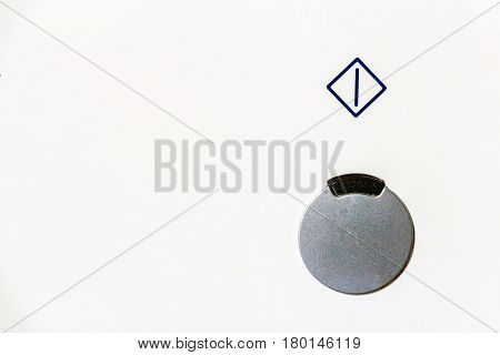 Closeup power button with symbol above it on white background
