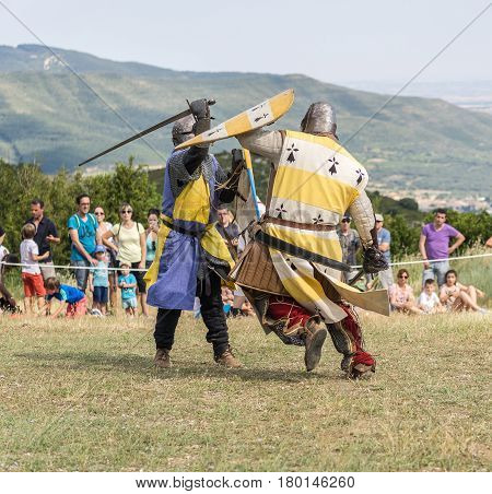 Loarre, Spain - July 09, 2016: Medieval reenactment with costumed characters and medieval armor with chainmail, helmet swords and shields. Battle demonstration and recreation